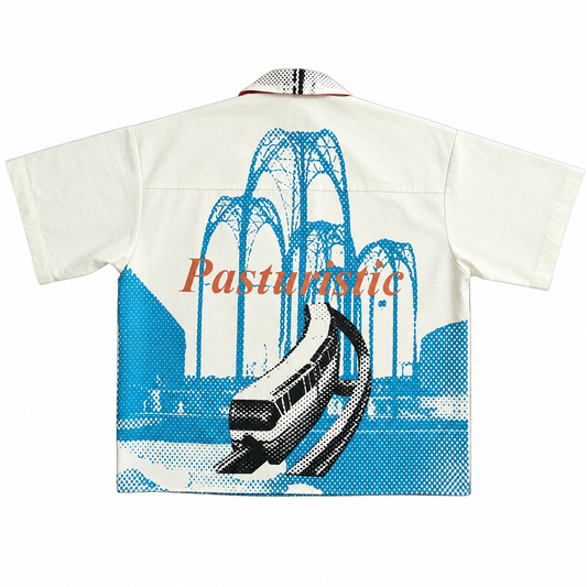 A short-sleeve camp-collar shirt shown flat against a white background, featuring a large graphic print of a monorail in blue and black halftone with the word 'Pasturionic' in orange across the center.