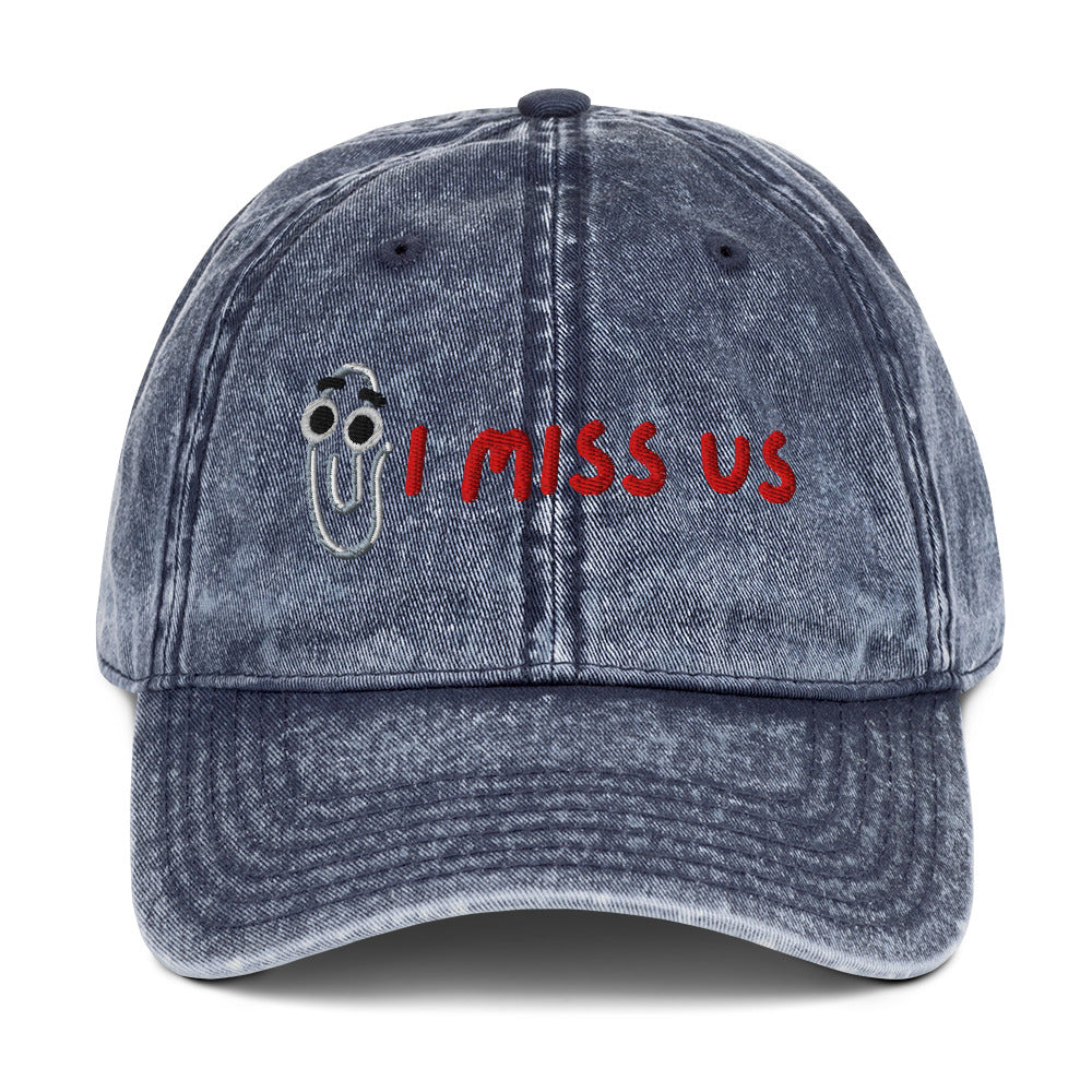 Blue denim cap with 'I MISS US' text and Clippy