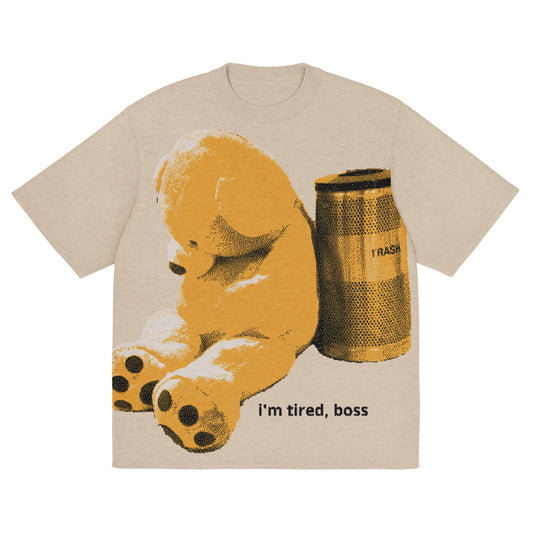 Beige t-shirt with a bear and trash can graphic and 'i'm tired, boss' text on a white background