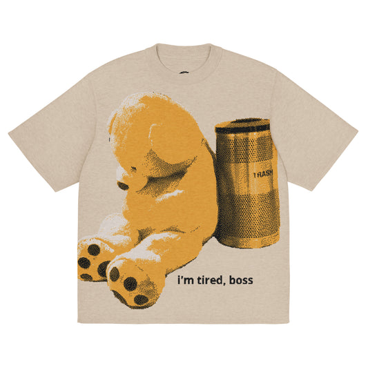 Beige t-shirt with a bear and trash can graphic and 'i'm tired, boss' text on a white background